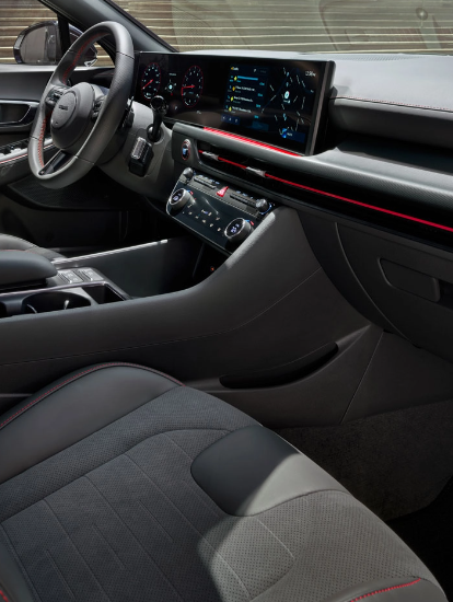Sporty Hyundai cabin with red contrast stitching, digital dash display, and ambient interior lighting.