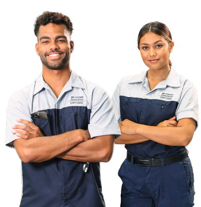 Two Hyundai technicians standing with arms crossed, smiling confidently.